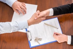 Top view of handshake of a real estate agent and a client.